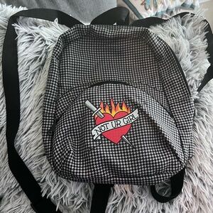 a.lab brand “Not UR Girl” mini backpack with front pocket.